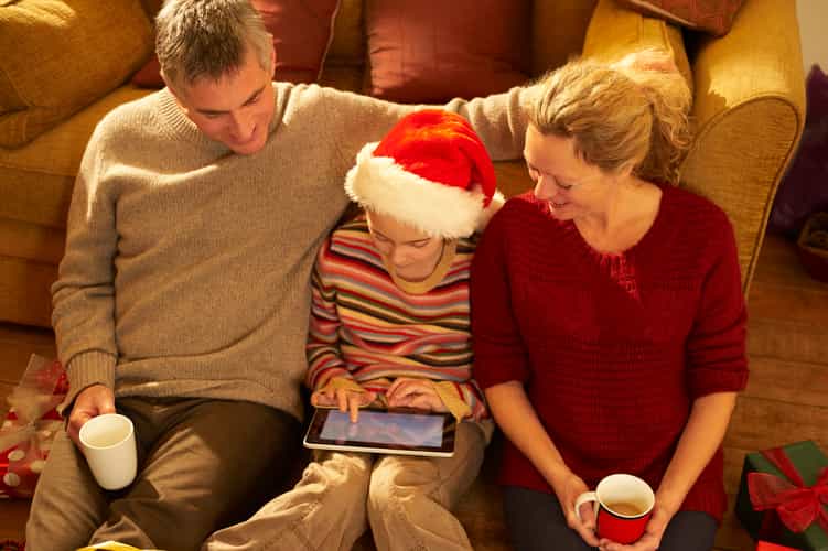 Familie mit Kind schauen Tablet